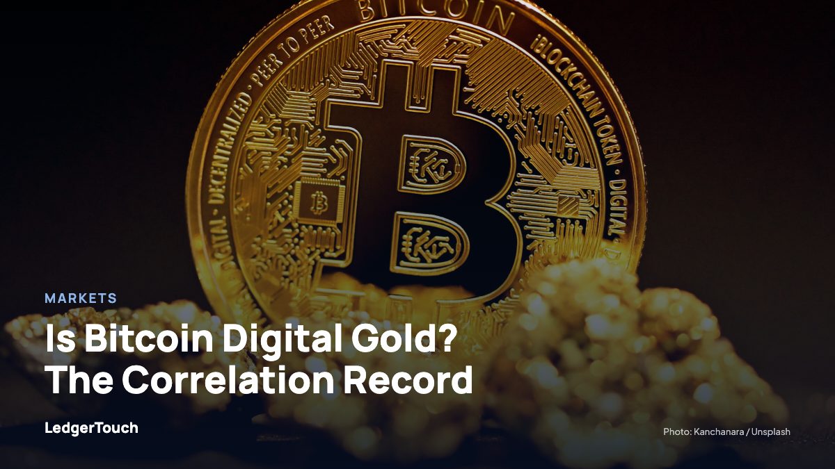A bitcoin sitting on top of a pile of gold nuggets.