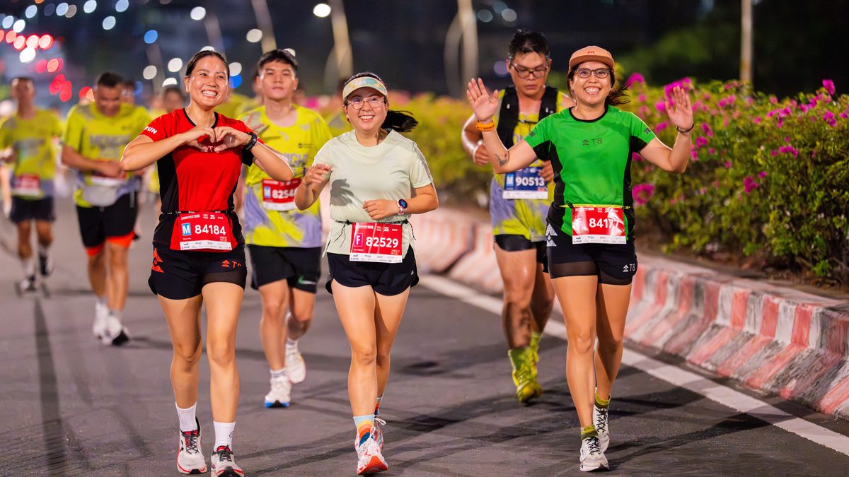Dynamic image of marathon participants running outdoors at night, showcasing endurance and joy.