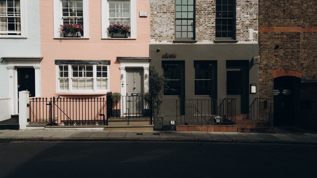Colorful townhouses in Notting Hill, London, showcasing classic architectural details.