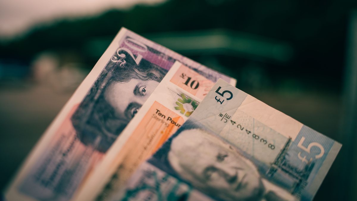 British five and ten pound notes close-up with blurred background.