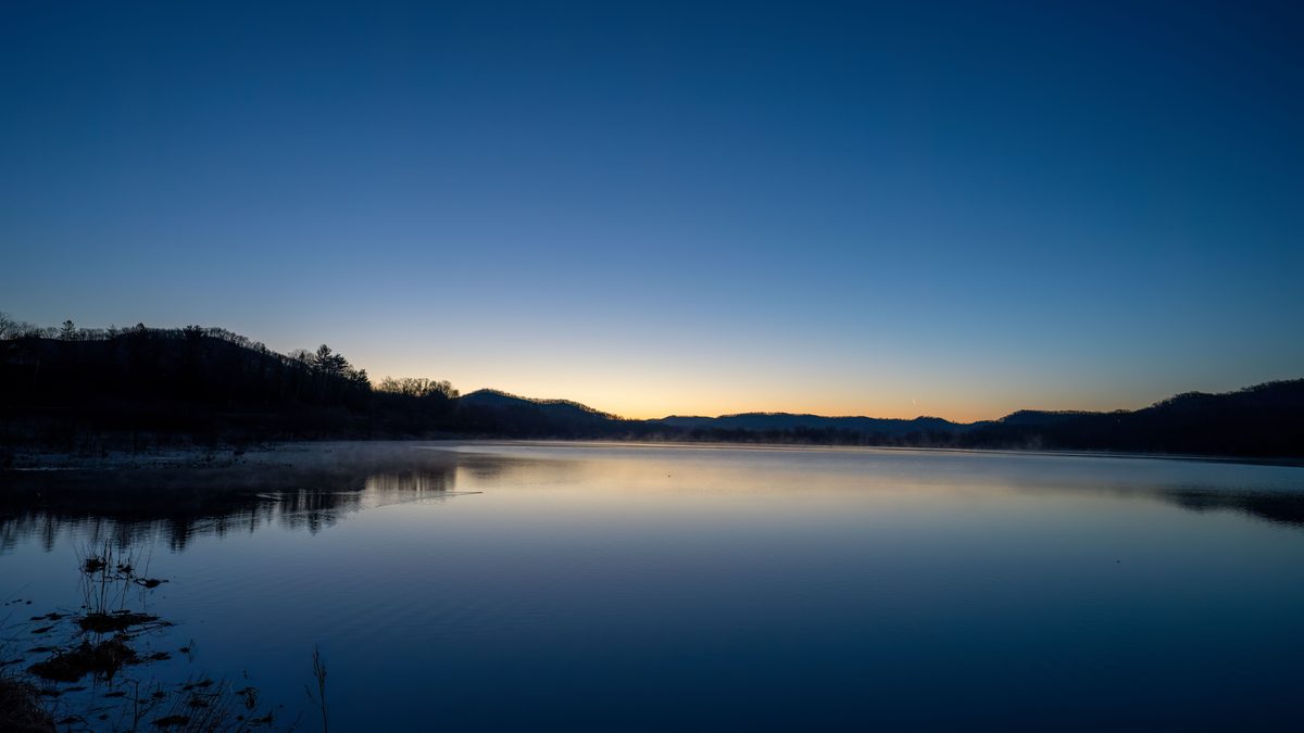 Peaceful sunset view over a serene lake in Tell, Wisconsin. Tranquility and natural beauty.