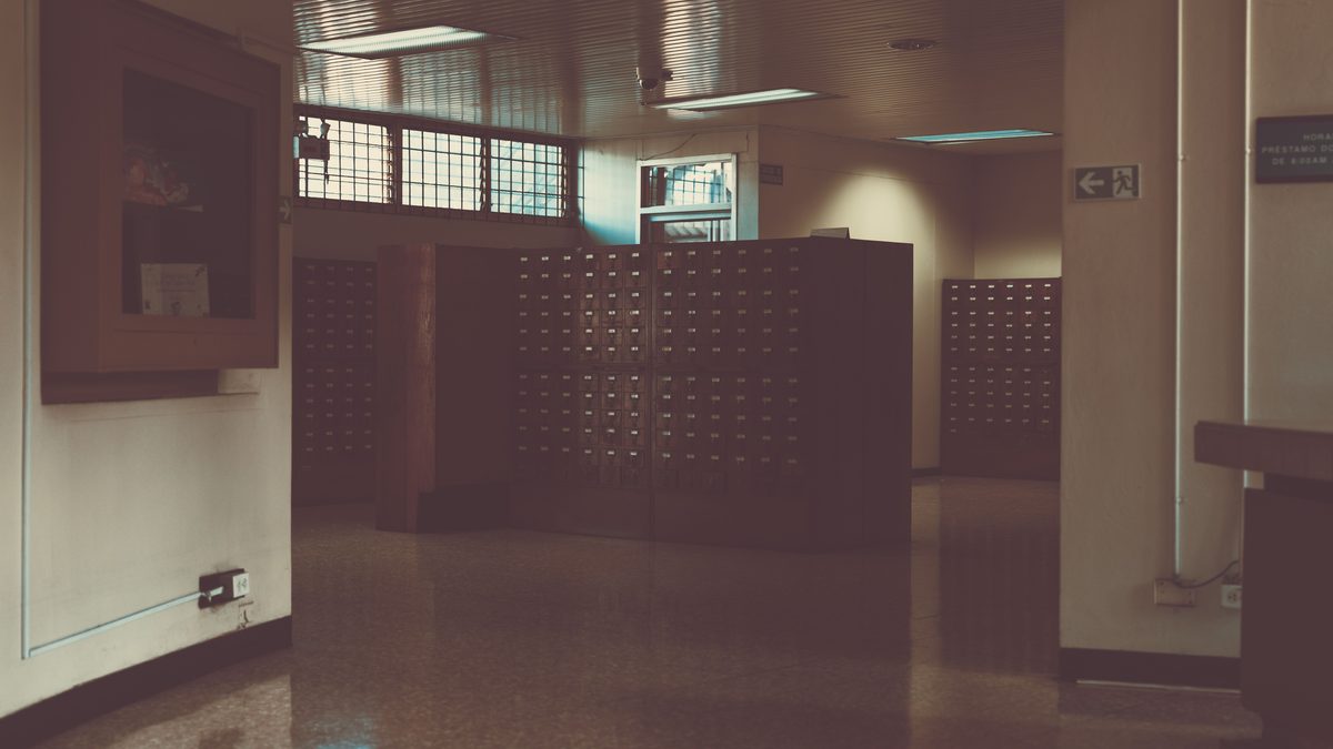 A dimly lit old library card catalog area in San José, Costa Rica.