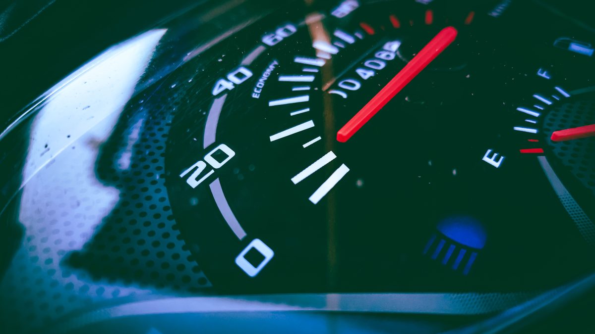 Detailed view of a speedometer and fuel gauge indicating measurement and fuel level.