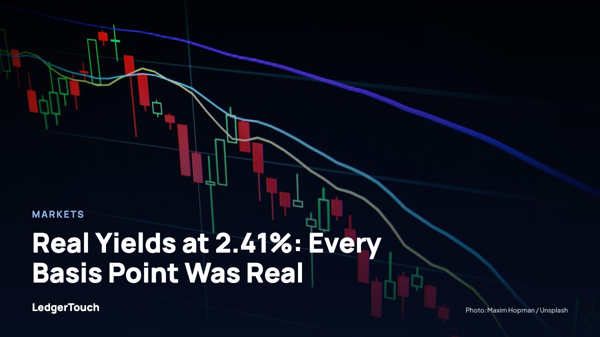 Stock market candlestick chart on dark screen.