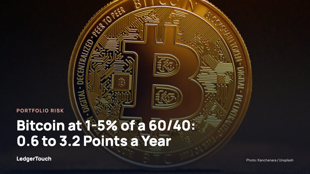 A golden bitcoin sitting on top of a table.