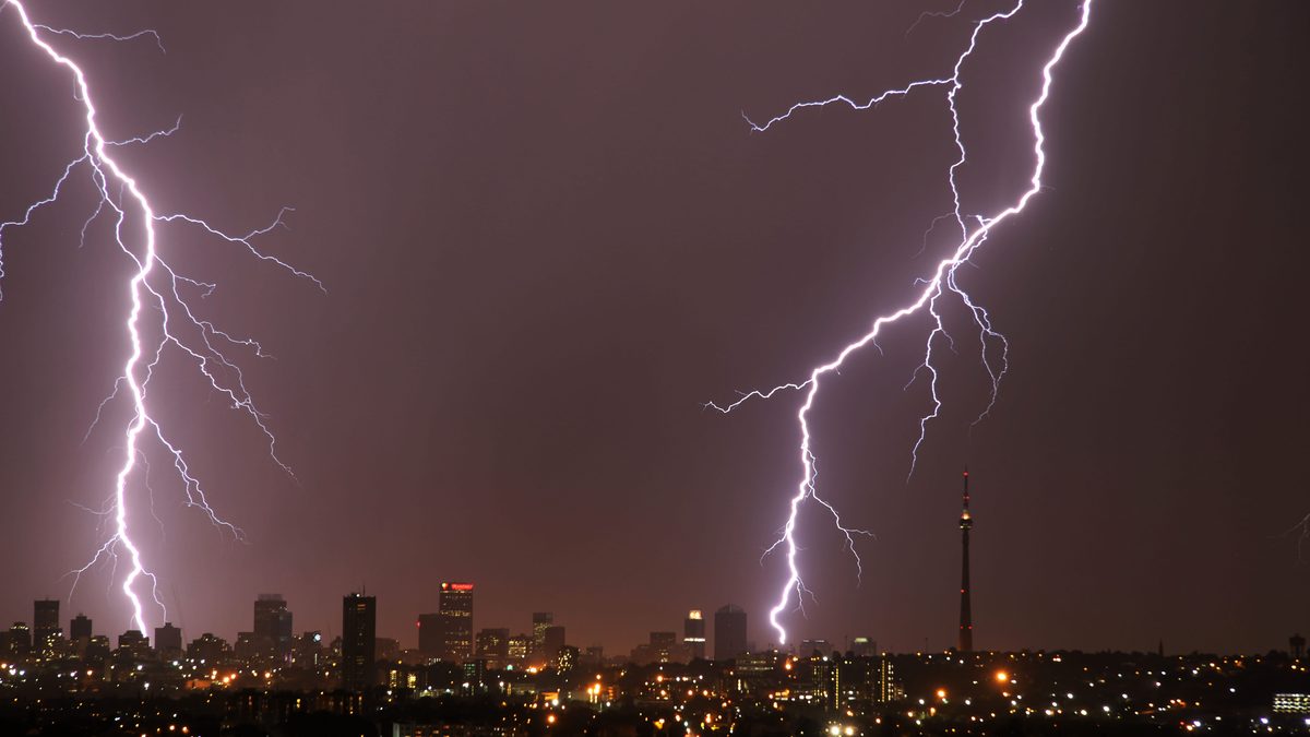 Captivating lightning strikes illuminate the Johannesburg skyline in a nighttime storm.