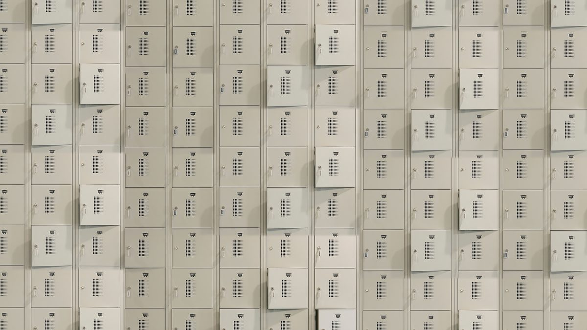 A uniform array of metal storage lockers with some doors slightly ajar, creating a geometric pattern.