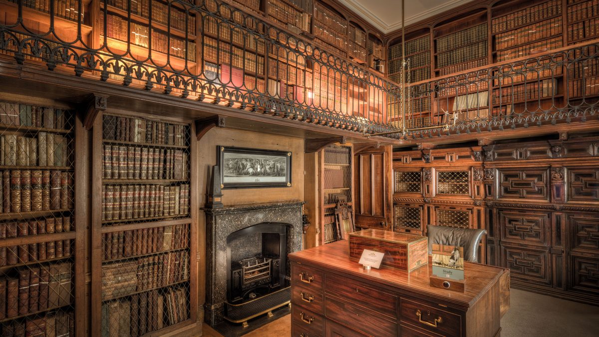 A historic library in Scotland featuring extensive wooden bookshelves filled with books.